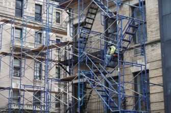 Shows Scaffolding on the Side of a New York Apartment Building Undergoing Repairs