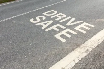 Drive Safe wording on road asphalt
