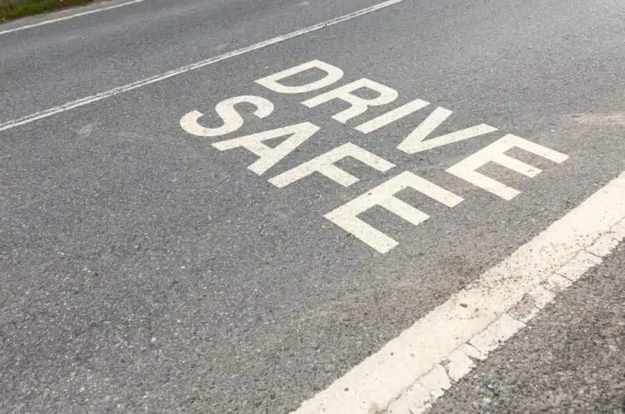 Drive Safe wording on road asphalt