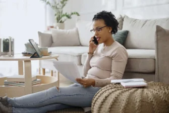 Woman on phone with agent reviewing her insurance policy